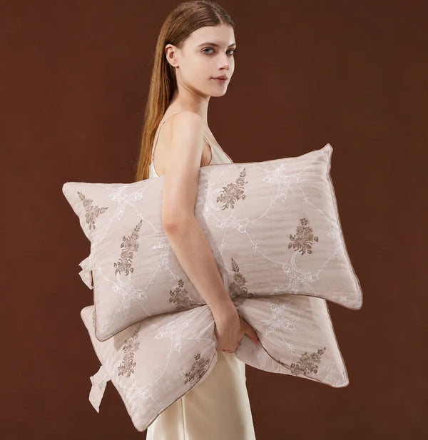 A model holding premium Egyptian cotton pillows in beige and brown featuring elegant floral design and 1000 thread count fabric showcasing lifestyle 