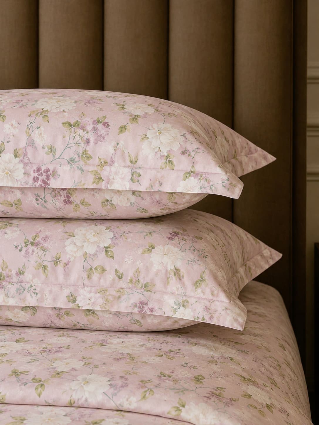 Two stack of pillows kept on luxury blush pink floral organic cotton pillow covers with 500 thread count bedsheet set for super king bed