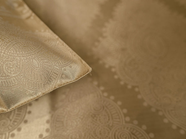 Close-up of champagne gold organic cotton jacquard bedsheet featuring premium woven texture and elegant look