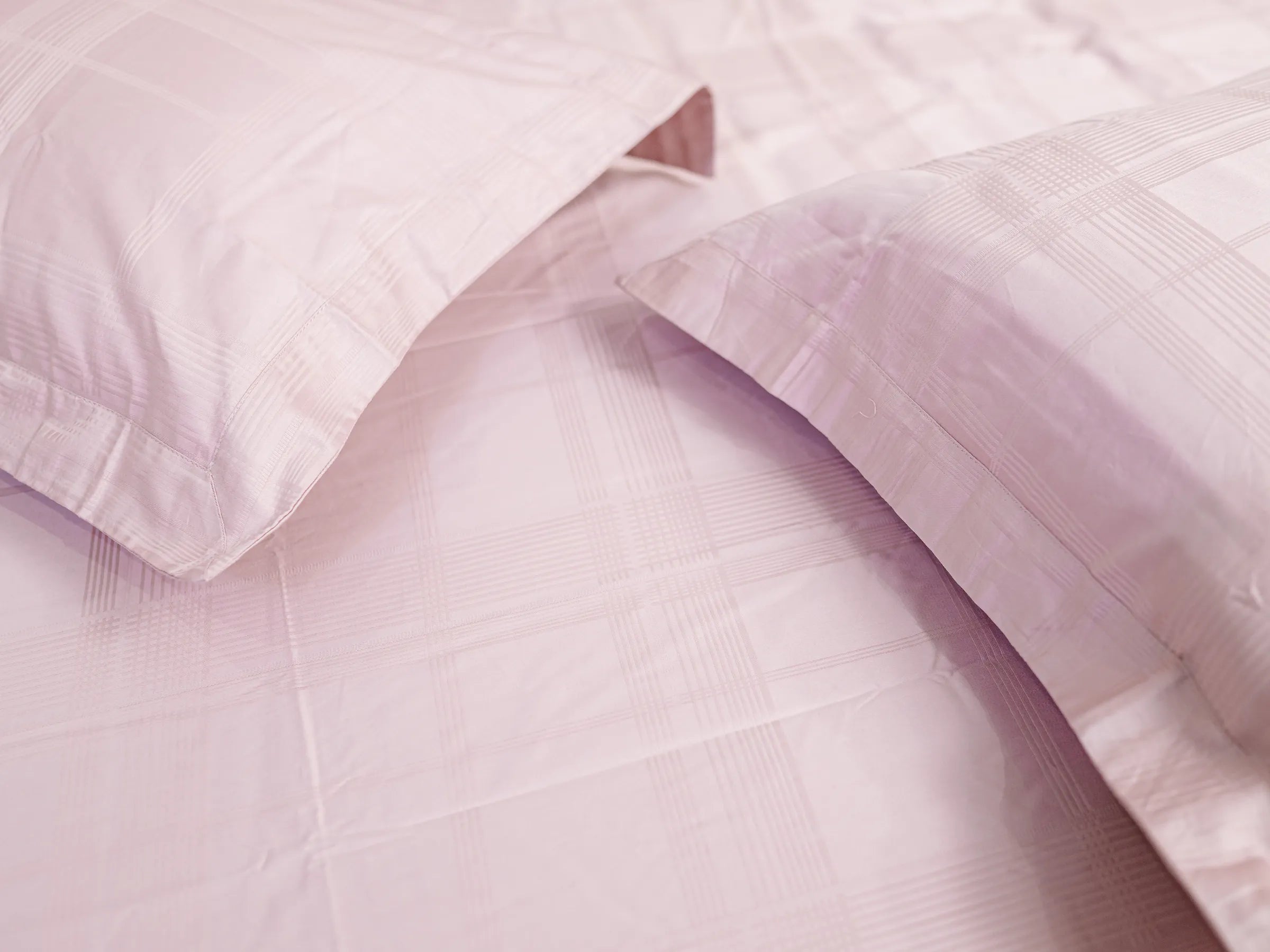 Close-up of Hush classic pink luxury bedsheet with matching pillow cover showcasing soft jacquard checks and premium cotton texture