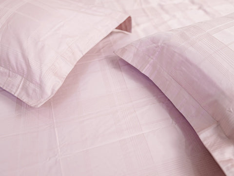 Close-up of Hush classic pink luxury bedsheet with matching pillow cover showcasing soft jacquard checks and premium cotton texture