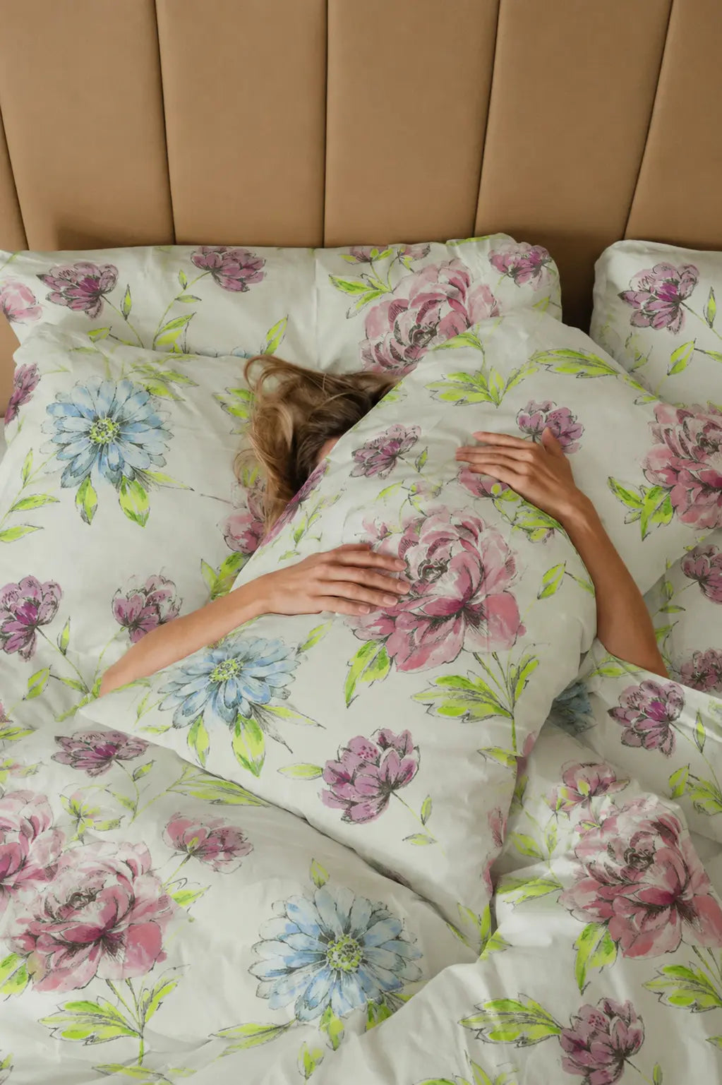Mosaic creamy white luxury bedsheet with dusty rose and cornflower blue floral print styled on a premium bed setup