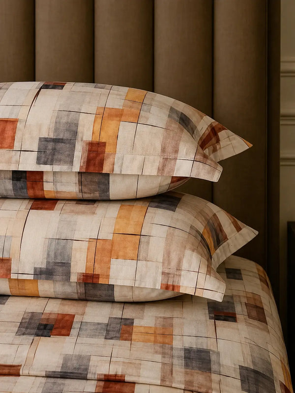 Stacked Spectrum pillow covers in off white and mocha abstract print showcasing premium cotton fabric and refined stitching