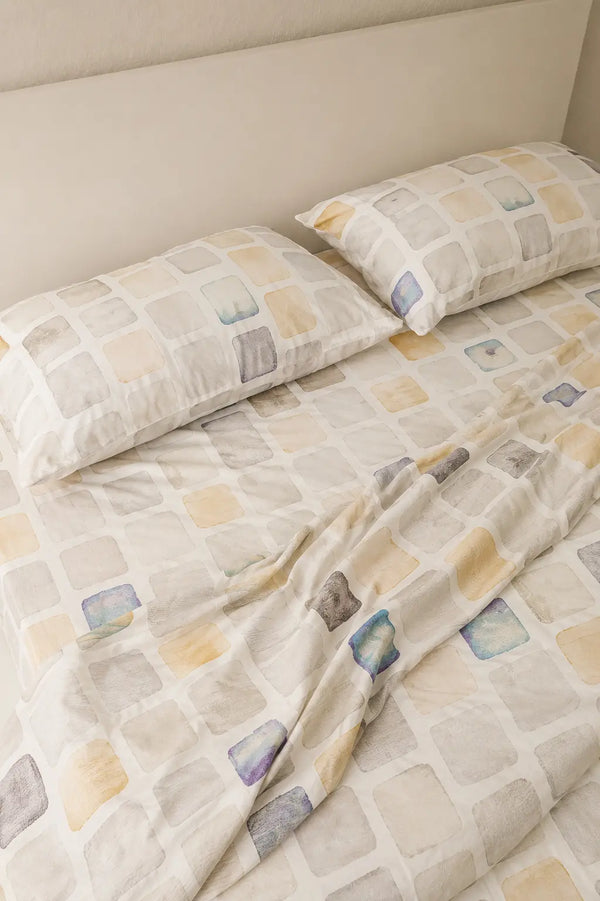 Motif off white luxury bedsheet with matching pillow covers showcasing contemporary watercolor geometric patterns on soft organic cotton 