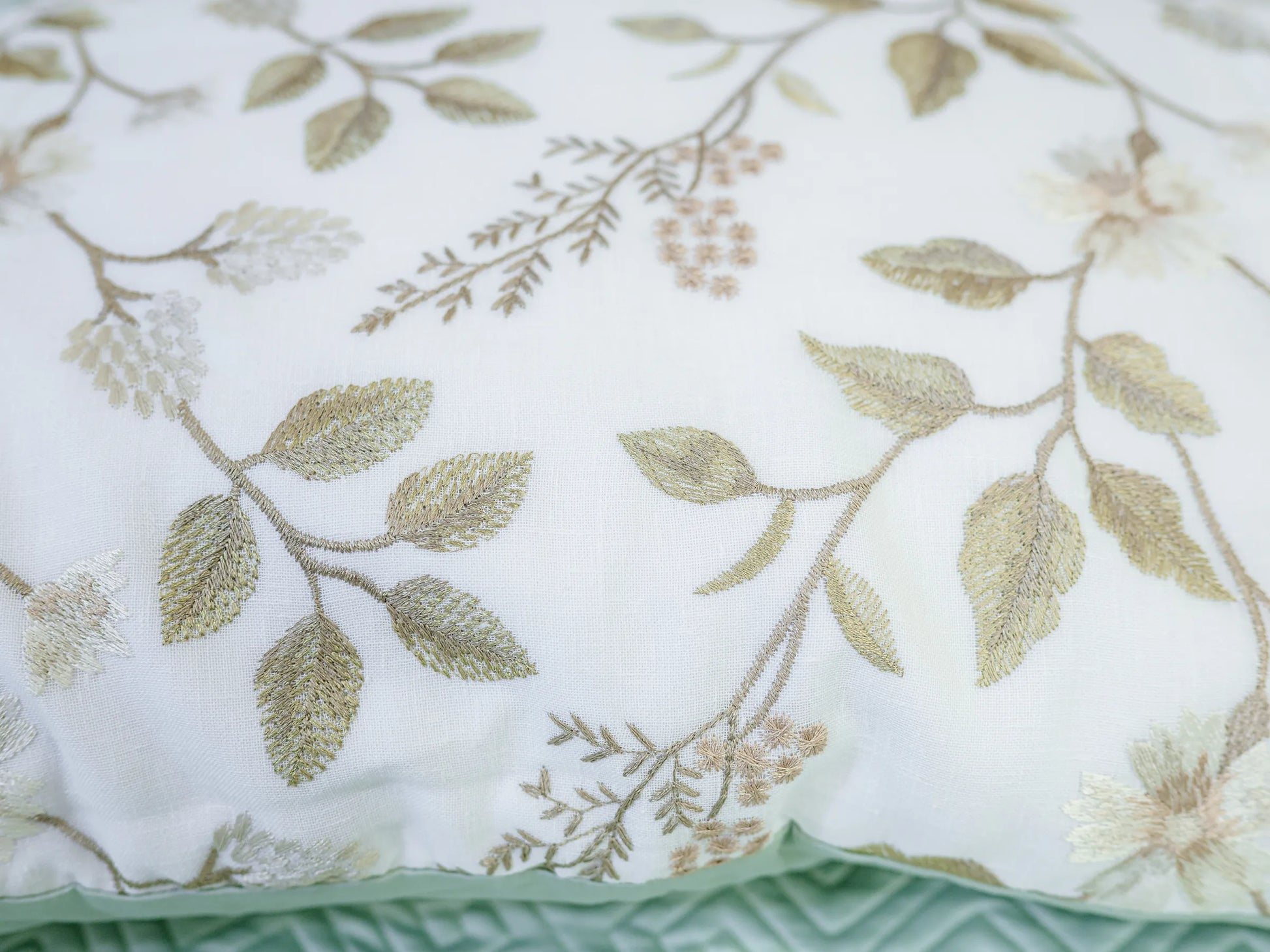 Luxury plush green 100% cotton quilted embroidered bedsheet with elegant geometric pattern and matching pillow cover showing craftsmanship for lifestyle