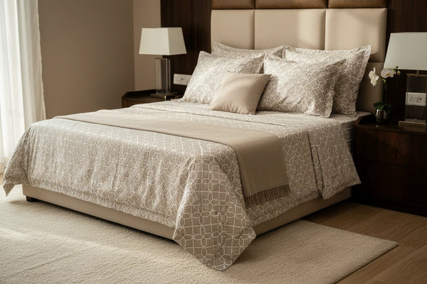 A lifestyle bedroom displaying Prism luxury almond cotton bedsheet styled on a modern bed with matching pillow covers and elegant geometric lattice design.