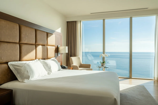 Apex luxury snow white cotton bedsheet styled in a premium hotel-inspired bedroom with ocean view and crisp self-striped finish
