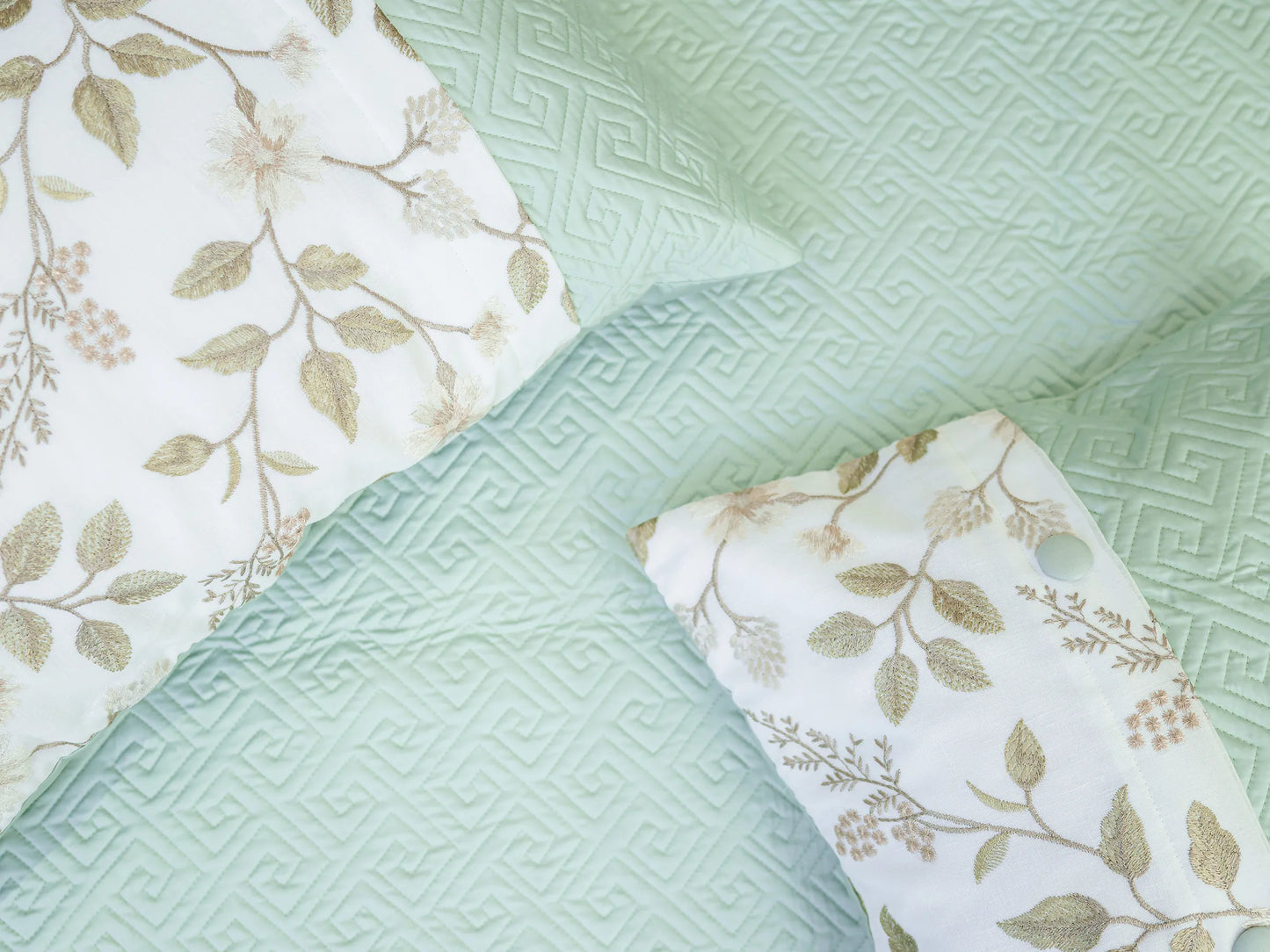Luxury plush green cotton quilted embroidered bedsheet with elegant geometric pattern and matching pillow cover