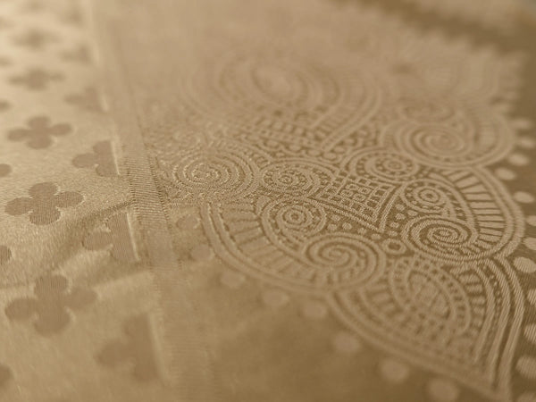 Detailed view of luxury champagne gold jacquard bedsheet showcasing intricate damask weave and 1000 thread count cotton fabric