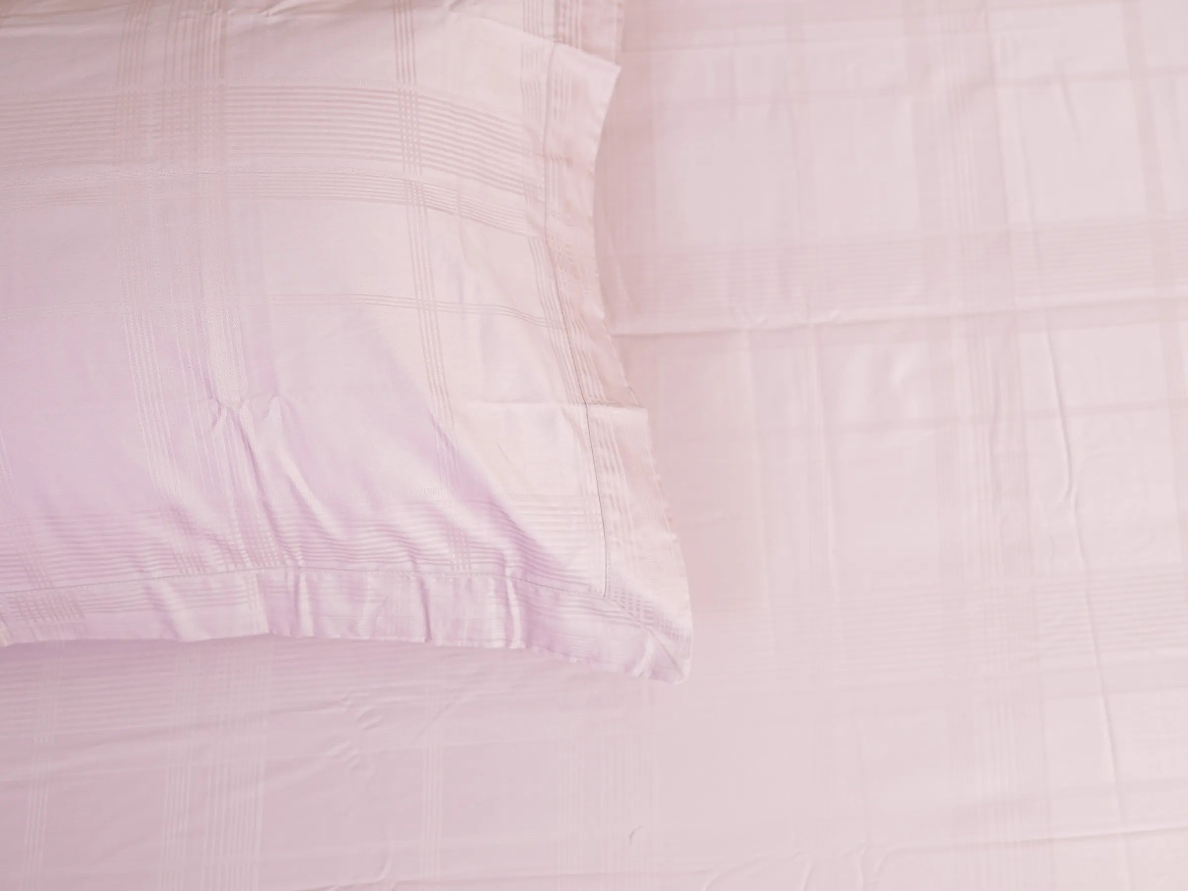 Hush 500 thread count cotton bedsheet in classic pink featuring subtle tonal plaid pattern and silky-smooth luxury finish