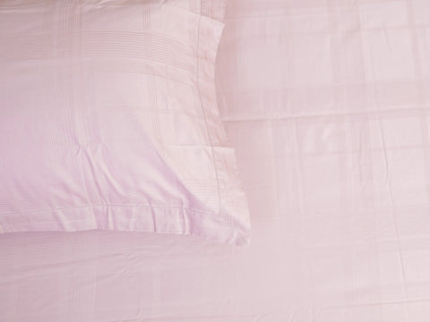 Hush 500 thread count cotton bedsheet in classic pink featuring subtle tonal plaid pattern and silky-smooth luxury finish