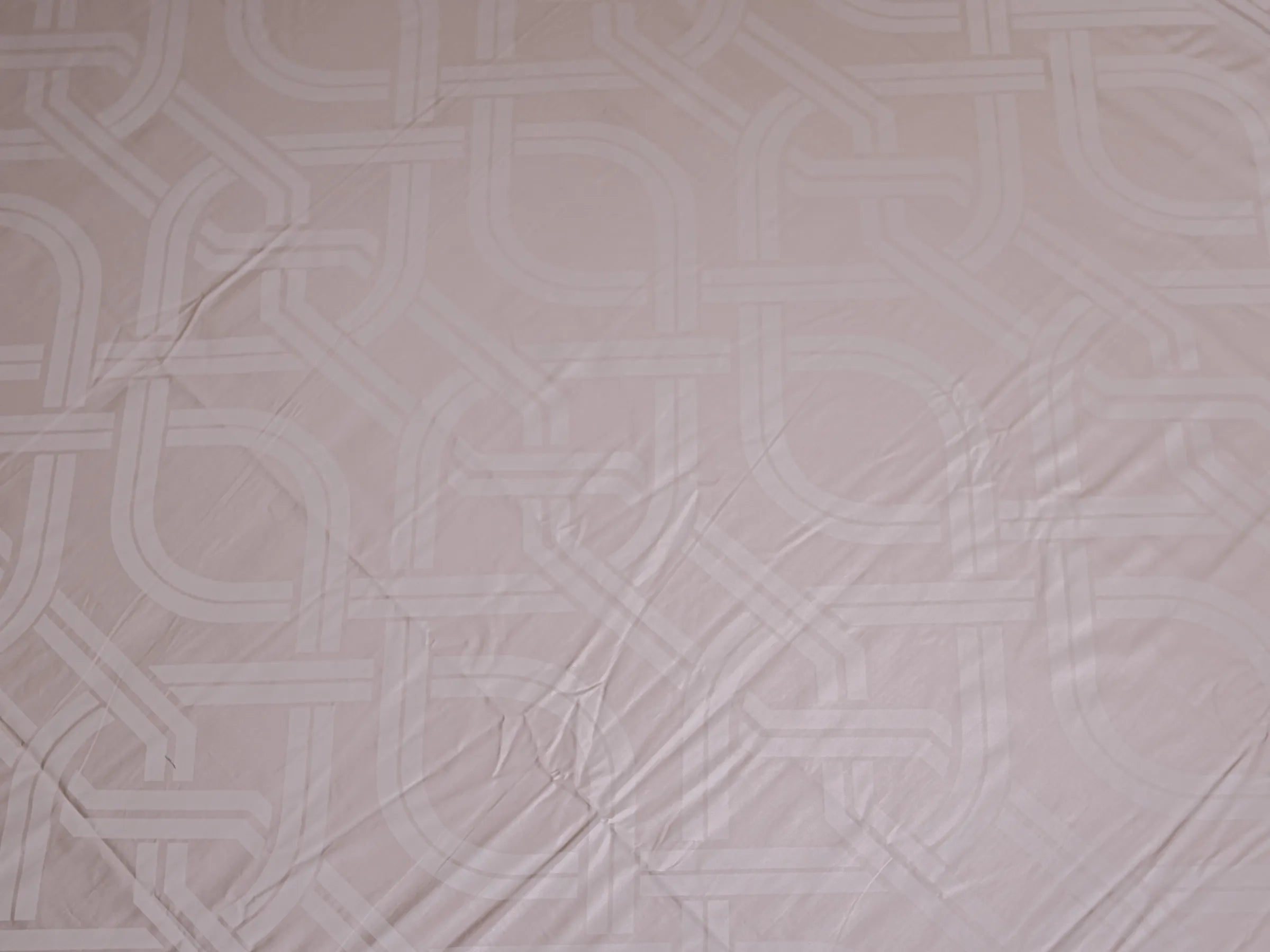 Detailed view of Pristine luxury grey cotton bedsheet highlighting sophisticated geometric interlocking design and silky-smooth finish