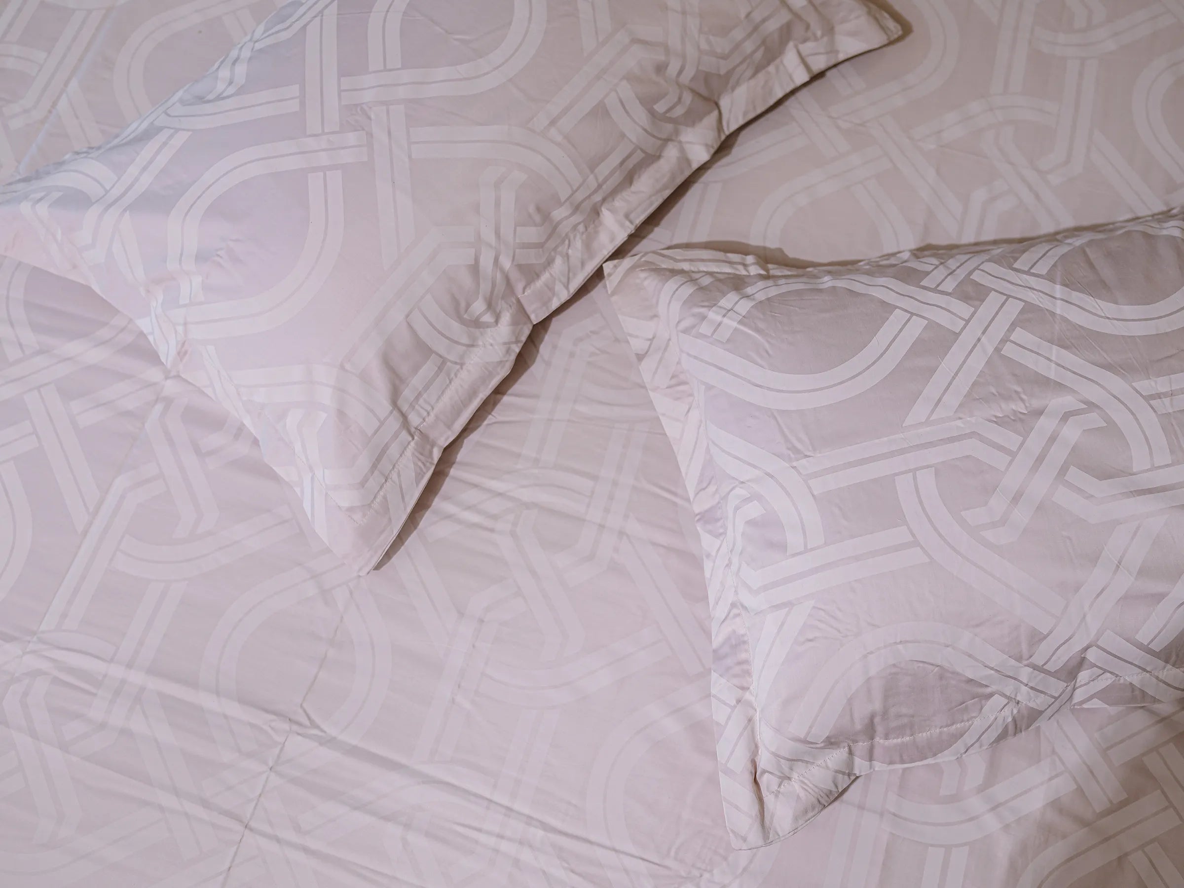 Close-up of Pristine grey luxury cotton bedsheet with matching pillow cover showcasing soft 500 thread count fabric and interlocking pattern