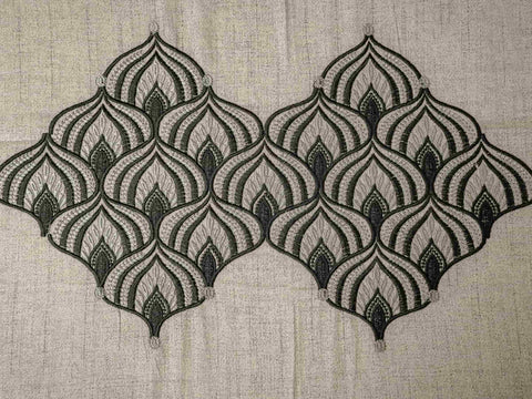 Close-up of Solace luxury bedsheet highlighting intricate self-embroidered geometric motifs on soft greyish blue 500 thread count cotton fabric.