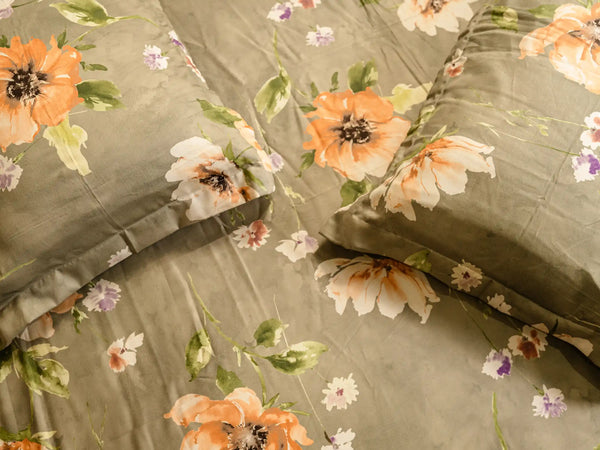 Close-up of Muse luxury cotton bedsheet with orange tropical flowers, smooth 500 thread count texture, and premium breathable finish