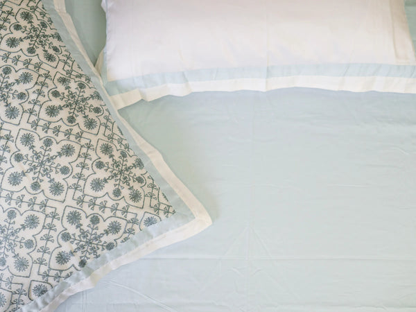 Premium Ice blue super king organic cotton bedsheet with one embroidered pillow cover showcasing intricate floral stitching and another plain pillow cover