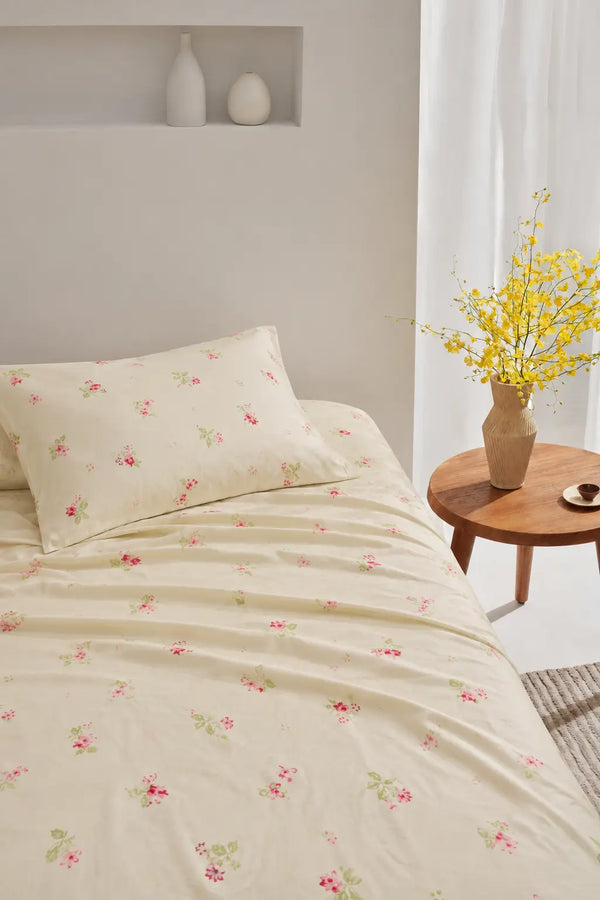 Palette panache green luxury bedsheet styled on a bright bedroom bed with delicate pink floral print and premium cotton finish.