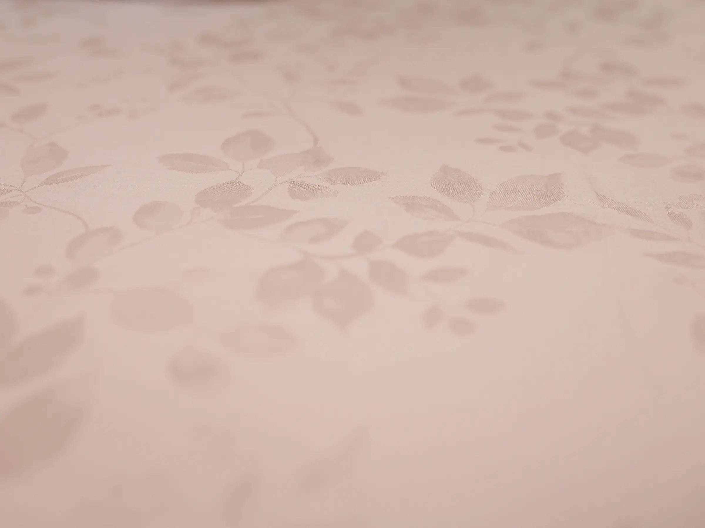 Close-up of pink champagne organic cotton jacquard bedsheet showcasing premium woven texture and elegant 1000 thread count fabric