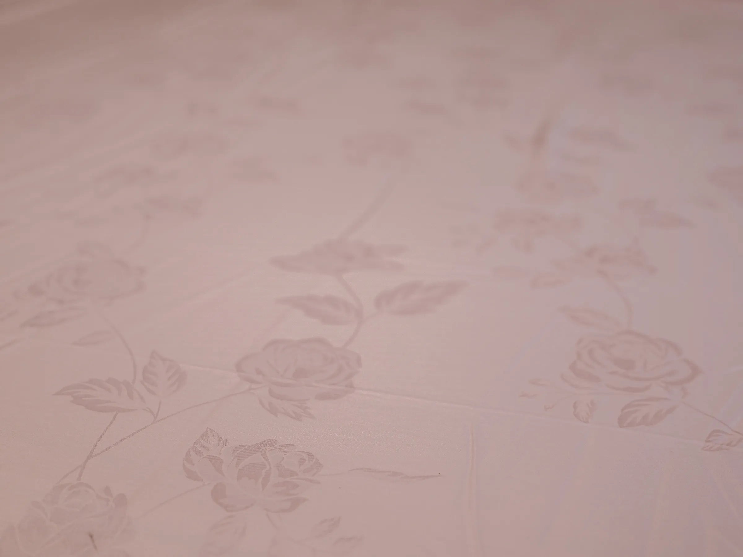 Close_up of rose gold organic cotton jacquard bedsheet showcasing premium woven texture and silky smooth 1000 thread count fabric