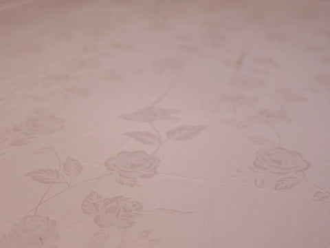 Close_up of rose gold organic cotton jacquard bedsheet showcasing premium woven texture and silky smooth 1000 thread count fabric