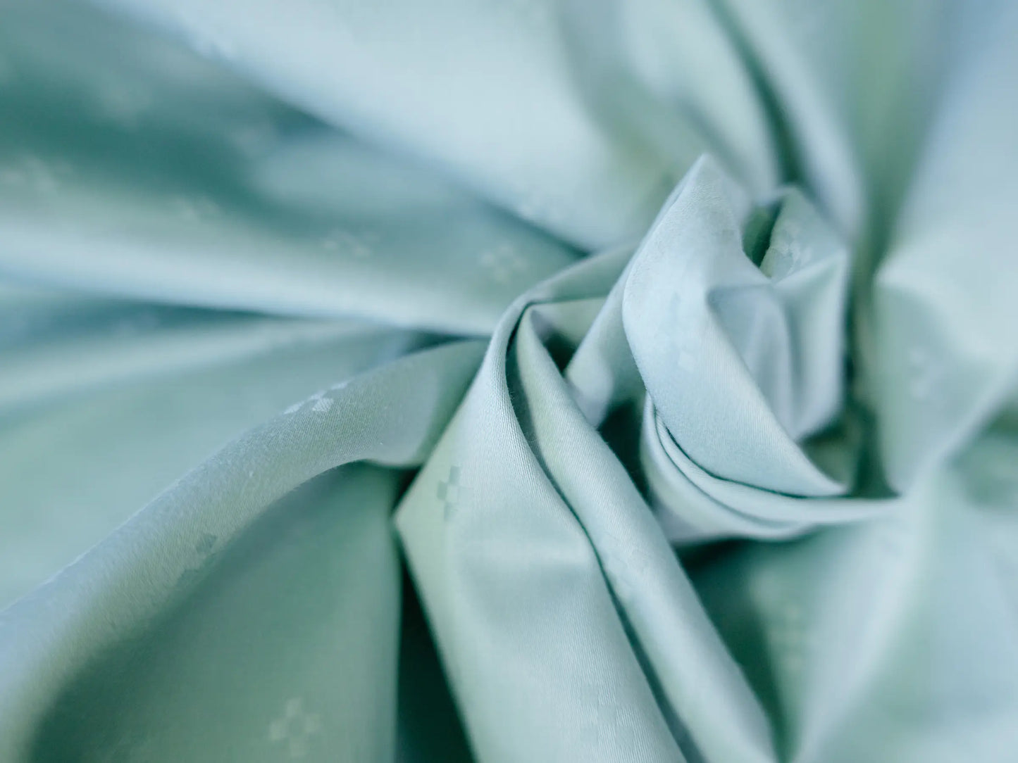 Premium organic cotton Swiss dot bedsheet folded to showcase rich texture, superior softness and luxury craftsmanship