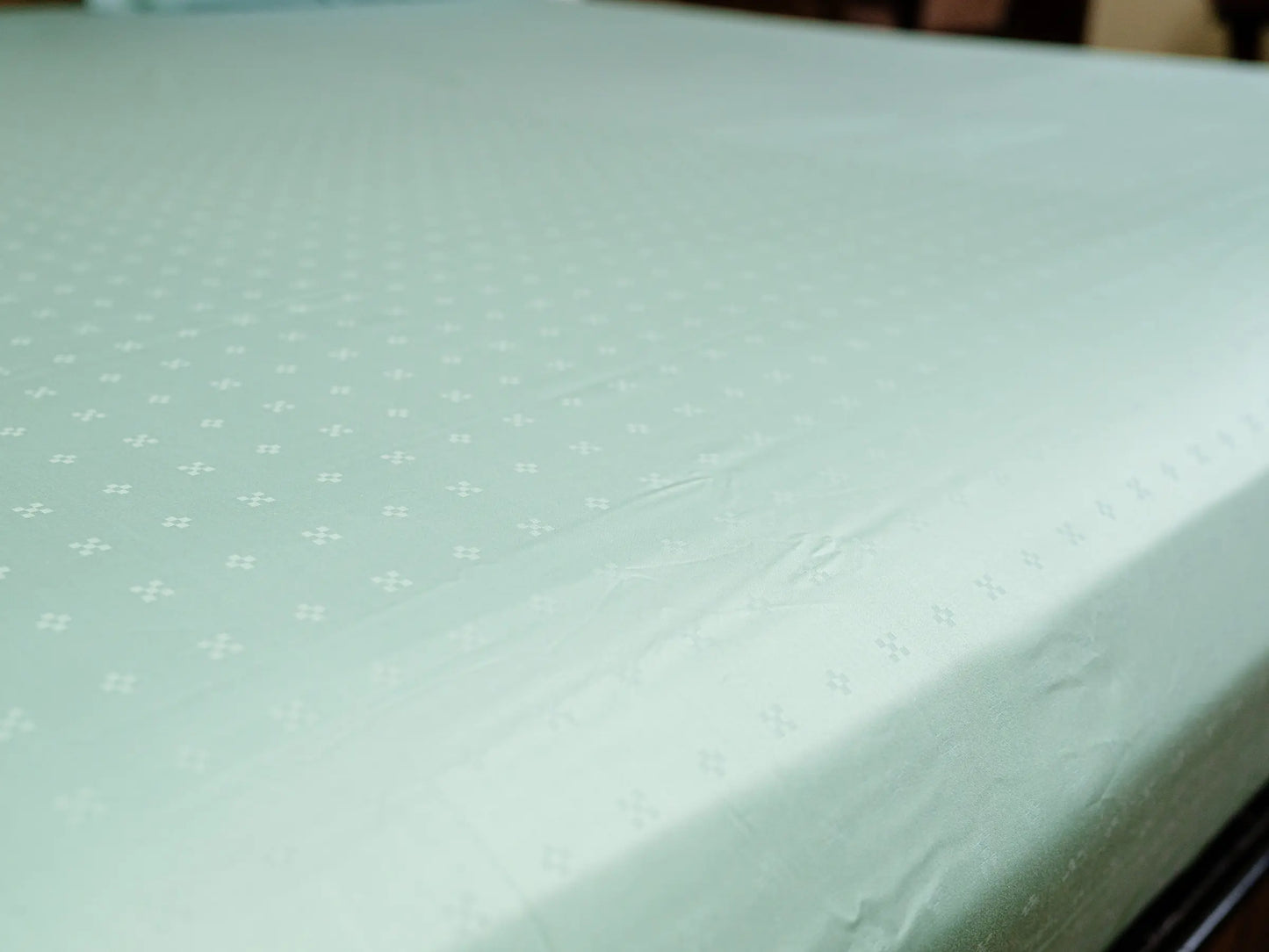 Luxury sea green cotton bedsheet with graceful drape and wrinkle-resistant finish for an elegant bedroom aesthetic