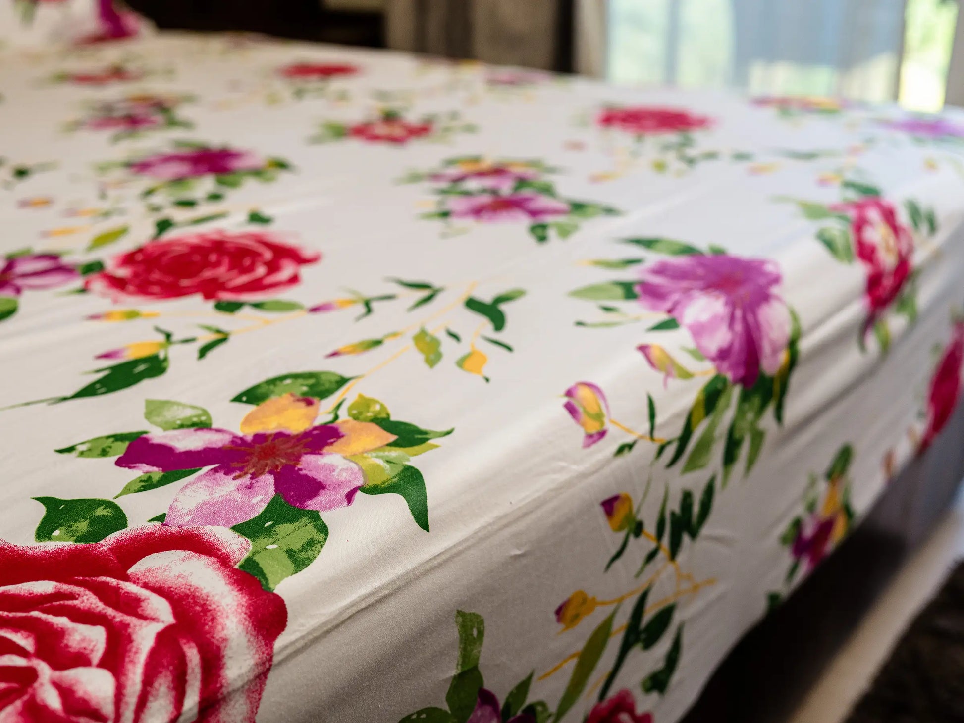 Wide view of Couture white and fuchsia floral luxury bedsheet showcasing premium organic cotton fabric and elegant botanical design