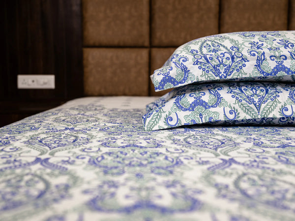 Stacked Kinetic pillow covers with matching bedsheet featuring intricate indigo damask print on smooth 500 thread count cotton